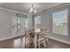Bright dining area with wood floors, stylish chandelier, and glass doors to the backyard at 1105 Alaska St, Hampton, GA 30228