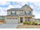 Charming two-story home with brick and siding, well-manicured lawn, and attached two car garage at 1105 Alaska St, Hampton, GA 30228