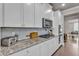 Gourmet kitchen featuring granite counters, a gas cooktop and modern stainless steel appliances at 1105 Alaska St, Hampton, GA 30228