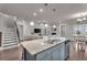Open concept kitchen featuring a large center island with bar seating, a view to the living room and dining area at 1105 Alaska St, Hampton, GA 30228