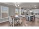 Open-concept kitchen and dining area with white cabinets and a large center island at 1105 Alaska St, Hampton, GA 30228