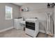 Modern laundry room equipped with a washer, dryer, folding table and ample shelving at 1105 Alaska St, Hampton, GA 30228