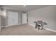 A spacious living room with neutral colored walls, carpeted floors and a keyboard piano at 1105 Alaska St, Hampton, GA 30228