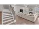 Staircase view of the living room featuring a fireplace and comfortable furnishings at 1105 Alaska St, Hampton, GA 30228