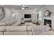Spacious living room with a cozy fireplace, plush sectional sofa, and plenty of natural light at 1105 Alaska St, Hampton, GA 30228