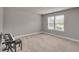 Bright and spacious living room with neutral walls, plush carpet and large windows at 1105 Alaska St, Hampton, GA 30228