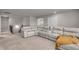 An open living room area featuring a sectional sofa, neutral walls, and plush carpet at 1105 Alaska St, Hampton, GA 30228