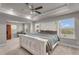 Spacious main bedroom boasts a tray ceiling, ceiling fan, and ample natural light at 1105 Alaska St, Hampton, GA 30228