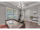 Bright office space with hardwood floors, coffered ceilings and large windows overlooking the front yard at 1105 Alaska St, Hampton, GA 30228
