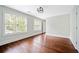 Spacious bedroom with hardwood flooring, two bright windows, and neutral wall paint at 1276 Dahlgren Se Ln, Atlanta, GA 30316