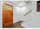 Inviting home foyer with hardwood floors, a stylish wood door, and stairs leading to the upper level at 1276 Dahlgren Se Ln, Atlanta, GA 30316
