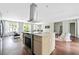 Open-concept kitchen and living area with modern lighting and stainless steel appliances at 1276 Dahlgren Se Ln, Atlanta, GA 30316