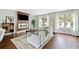 Bright living room featuring a modern fireplace, beautiful hardwood floors, and multiple windows at 1276 Dahlgren Se Ln, Atlanta, GA 30316
