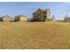 Large backyard with a well-maintained lawn and a view of the home's back exterior at 132 Windmeadow Way, Fayetteville, GA 30214