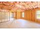 Spacious unfinished basement with exposed beams, insulation, and natural light from the windows at 132 Windmeadow Way, Fayetteville, GA 30214