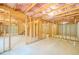 Large unfinished basement featuring exposed framing, pink insulation, and a concrete floor at 132 Windmeadow Way, Fayetteville, GA 30214