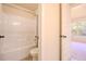 Bright bathroom featuring a shower-tub combination with neutral tile and finishes at 132 Windmeadow Way, Fayetteville, GA 30214