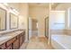 Luxurious bathroom with double vanity sinks, a glass-enclosed shower, and a soaking tub at 132 Windmeadow Way, Fayetteville, GA 30214