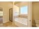 Bathroom featuring soaking tub, tiled shower, and private commode at 132 Windmeadow Way, Fayetteville, GA 30214