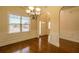 Dining room featuring a chandelier, wainscoting, and a large window for natural light at 132 Windmeadow Way, Fayetteville, GA 30214