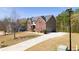 Traditional brick home with a long driveway and a spacious, well-maintained front lawn at 132 Windmeadow Way, Fayetteville, GA 30214