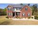 Charming brick two-story home with well-manicured front yard and classic architectural details at 132 Windmeadow Way, Fayetteville, GA 30214
