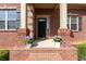 Close-up of front porch with elegant columns and potted plants, showcasing curb appeal at 132 Windmeadow Way, Fayetteville, GA 30214
