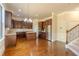 Well-equipped kitchen with stainless steel appliances, island, wood cabinetry, and hardwood flooring at 132 Windmeadow Way, Fayetteville, GA 30214