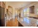 Bright kitchen featuring granite countertops, stainless steel appliances, and hardwood floors at 132 Windmeadow Way, Fayetteville, GA 30214
