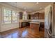 Modern kitchen with granite countertops, island, stainless steel appliances, and natural light at 132 Windmeadow Way, Fayetteville, GA 30214