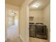 A laundry room with new washer and dryer units, and wire shelving at 132 Windmeadow Way, Fayetteville, GA 30214