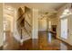 Open-concept living room with a fireplace, coffered ceilings, hardwood floors, and a staircase at 132 Windmeadow Way, Fayetteville, GA 30214