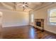 Cozy living area features a stone fireplace, coffered ceiling, hardwood flooring and natural lighting at 132 Windmeadow Way, Fayetteville, GA 30214