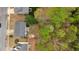 A high aerial view shows the home and it's yard, neighbords and surrounding trees at 2155 Westwind Dr, Roswell, GA 30075