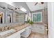 The bathroom boasts double vanities, a garden tub, and glass shower creating a luxurious spa-like experience at 2155 Westwind Dr, Roswell, GA 30075