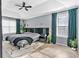 This bedroom boasts a sleek modern design, a tray ceiling with fan, and natural light streaming through the windows at 2155 Westwind Dr, Roswell, GA 30075