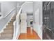 Bright foyer with hardwood floors, staircase, and view into dining area creating an inviting entrance at 2155 Westwind Dr, Roswell, GA 30075
