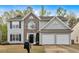 Charming two-story home with stone accents, a two-car garage, and well-maintained landscaping at 2155 Westwind Dr, Roswell, GA 30075
