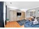Comfortable living area with built-in entertainment center, hardwood floors, and an adjacent dining room at 2155 Westwind Dr, Roswell, GA 30075