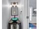 Elegant powder room with a unique vessel sink, modern fixtures, and stylish decor at 2155 Westwind Dr, Roswell, GA 30075