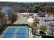 Aerial view of community amenities including tennis and basketball courts, pool, and playground by the lake at 3053 Cambridge Hill Dr, Dacula, GA 30019