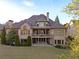 Beautiful backyard with well-maintained lawn, mature trees, and covered patio at 3053 Cambridge Hill Dr, Dacula, GA 30019