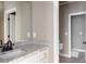 Bathroom featuring granite countertops, a large mirror, and neutral tile flooring at 3053 Cambridge Hill Dr, Dacula, GA 30019
