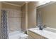 Bathroom featuring granite countertops, a soaking tub with shower, and neutral toned tile and fixtures at 3053 Cambridge Hill Dr, Dacula, GA 30019
