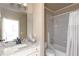 Bathroom featuring granite countertops, a soaking tub with shower, and neutral toned tile and fixtures at 3053 Cambridge Hill Dr, Dacula, GA 30019