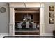 Elegant dining room with decorative columns, a crystal chandelier, and seating for eight at 3053 Cambridge Hill Dr, Dacula, GA 30019