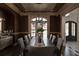 Elegant dining room with coffered ceiling, chandelier, and large windows, perfect for gatherings at 3053 Cambridge Hill Dr, Dacula, GA 30019