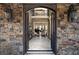 Grand foyer showcasing a marble floor, stone walls, and an open view to the piano room at 3053 Cambridge Hill Dr, Dacula, GA 30019