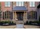 Elegant brick and stone home featuring a covered entryway with stone columns and a double door at 3053 Cambridge Hill Dr, Dacula, GA 30019