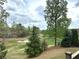 Scenic view of golf course near property with mature trees and well manicured landscaping at 3053 Cambridge Hill Dr, Dacula, GA 30019
